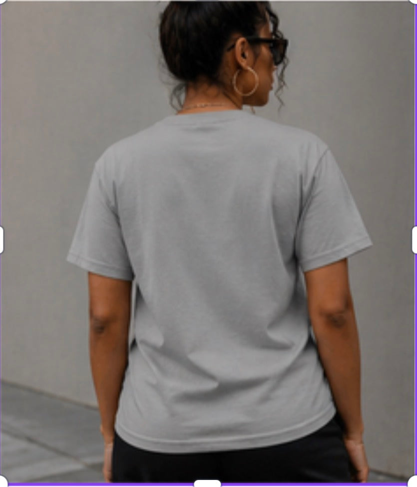 Person wearing a plain gray t-shirt against a neutral background