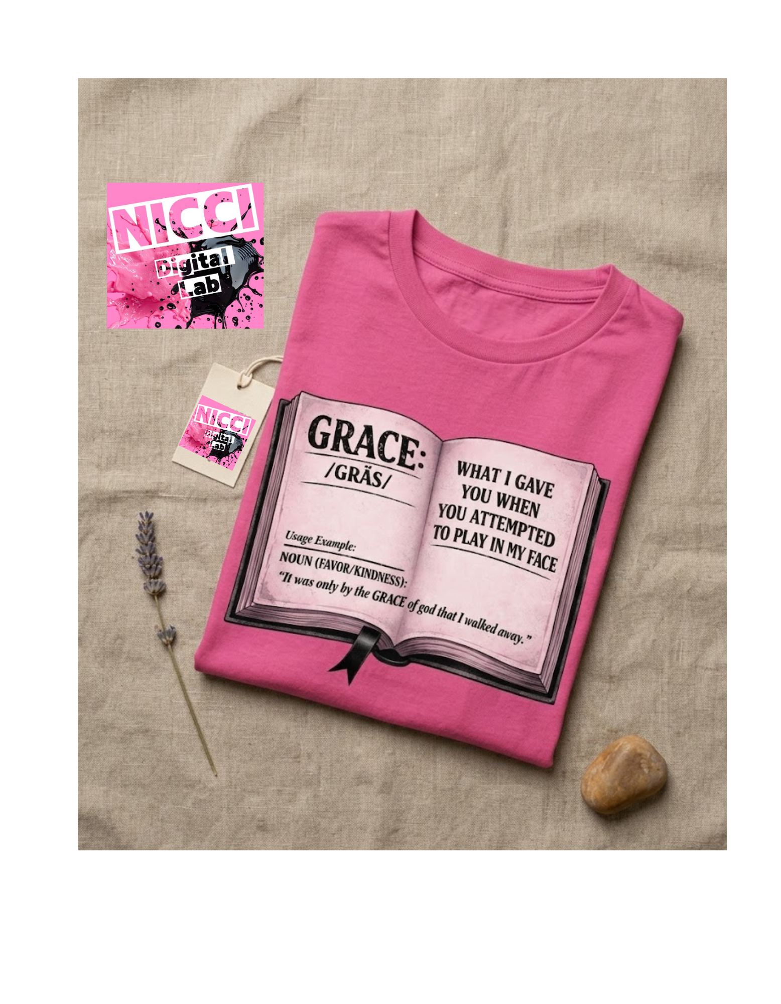 Pink t-shirt with graphic design and text on a textured surface